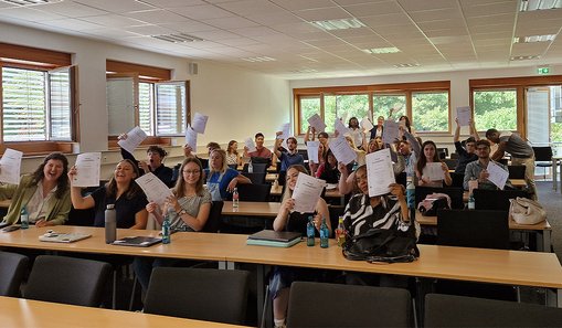 Gruppenfoto auf dem die Teilnehmenden der Summer School ihre Zertifikate hochhalten. 